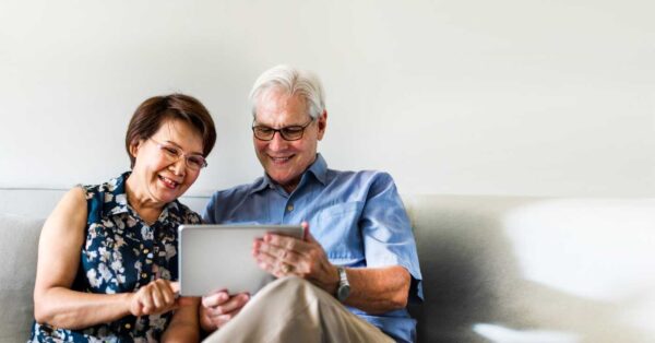 senior-couple-using-digital-device-in-living-room (3)